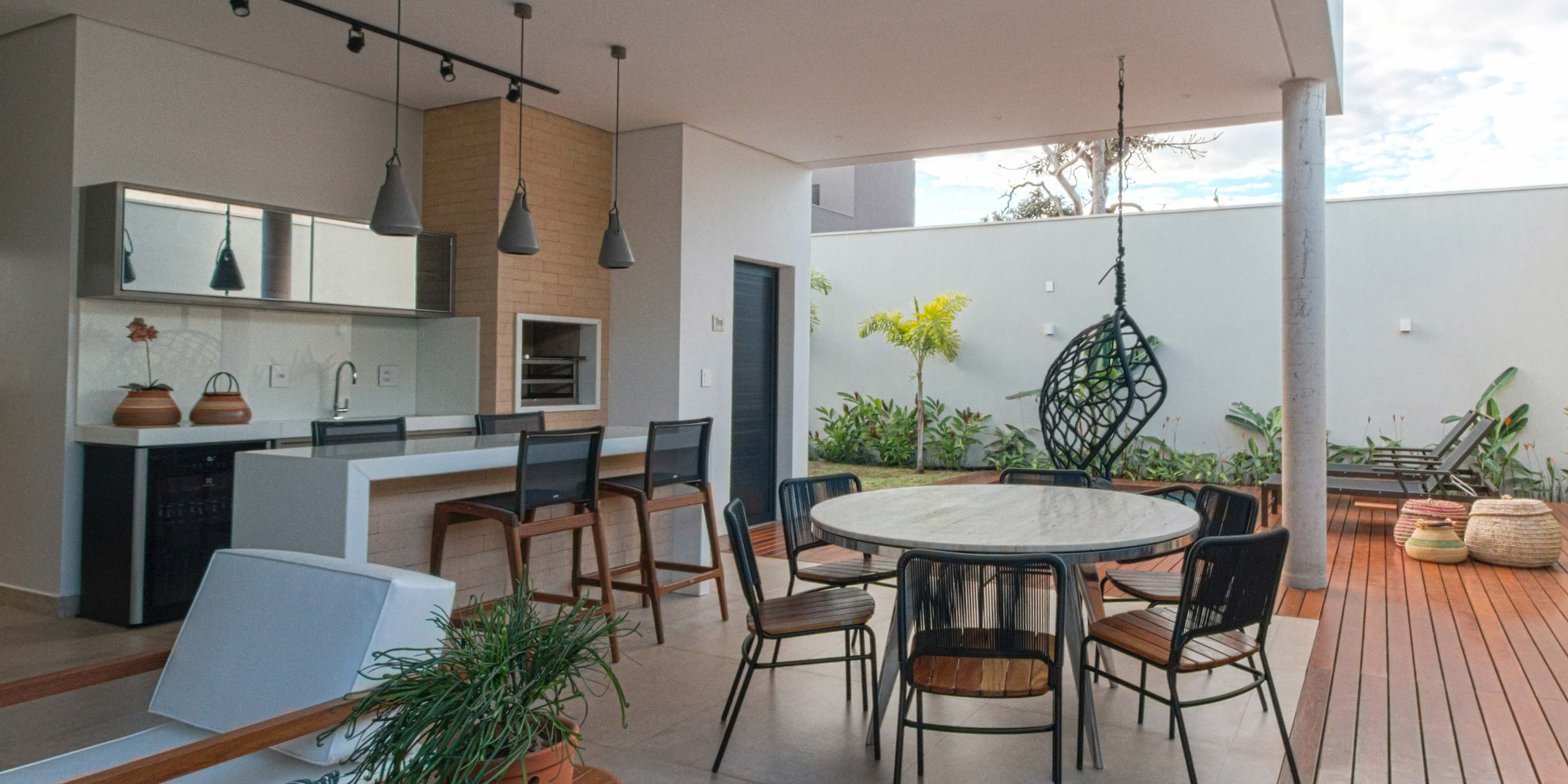 outdoor kitchen with modern lighting and furnishings