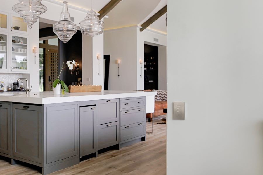 A kitchen area with a Palladiom keypad displayed on the wall.