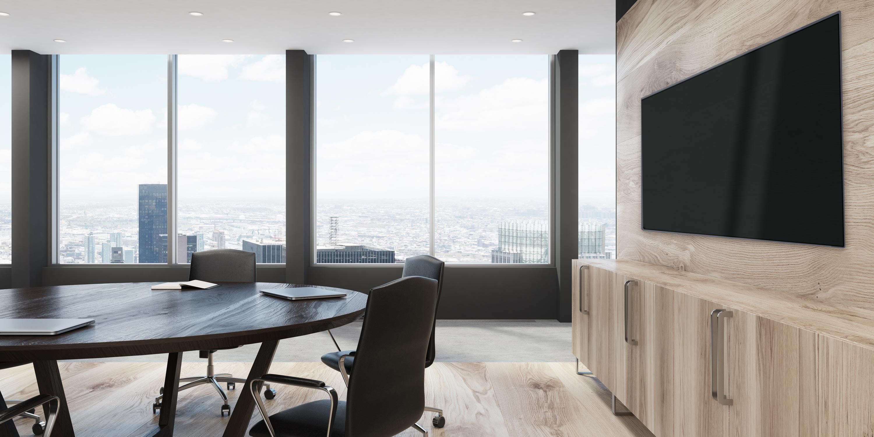 clean and modern conference room with wooden furniture and city views