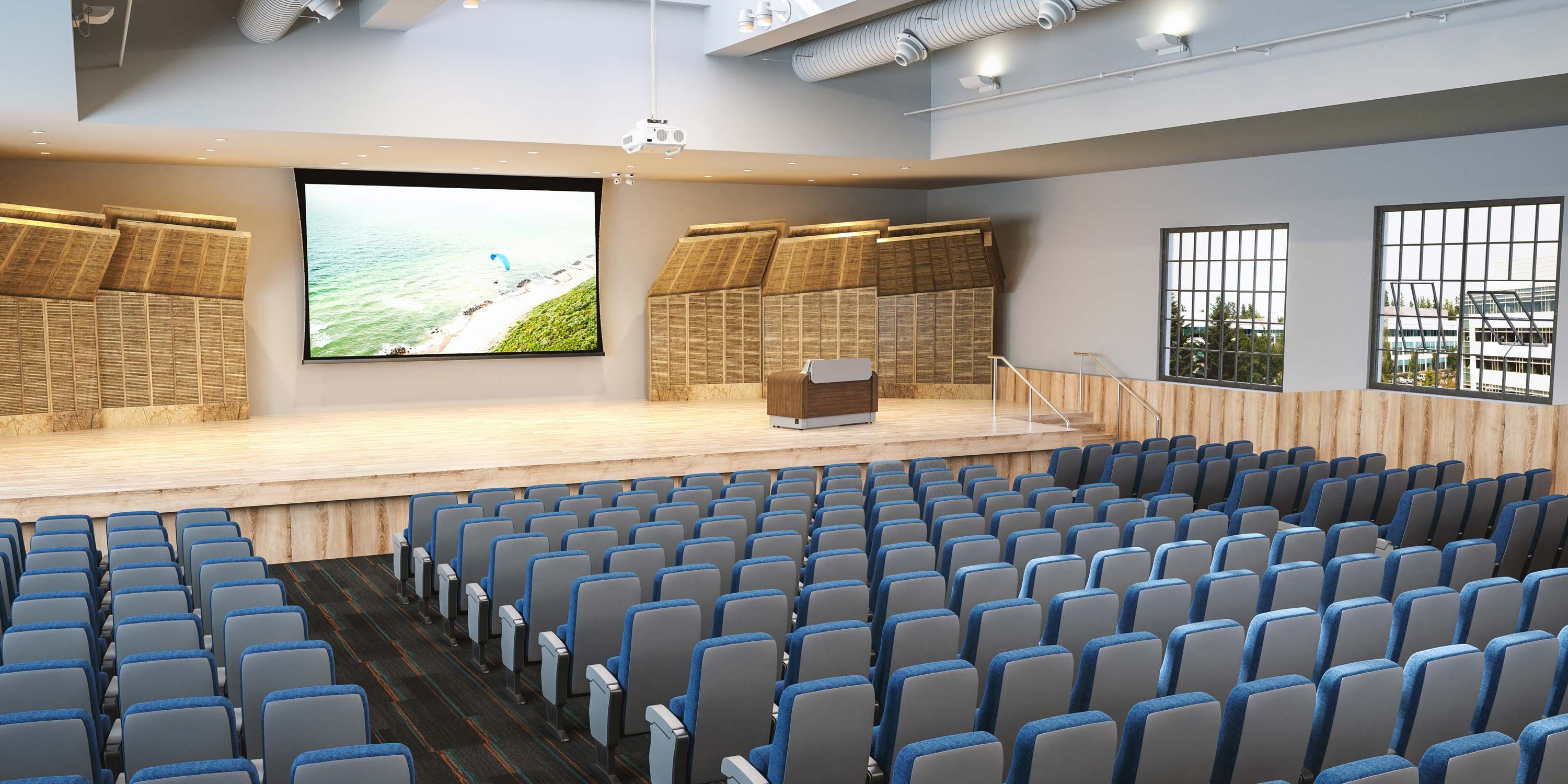 higher education auditorium with blue chairs and a projector screen