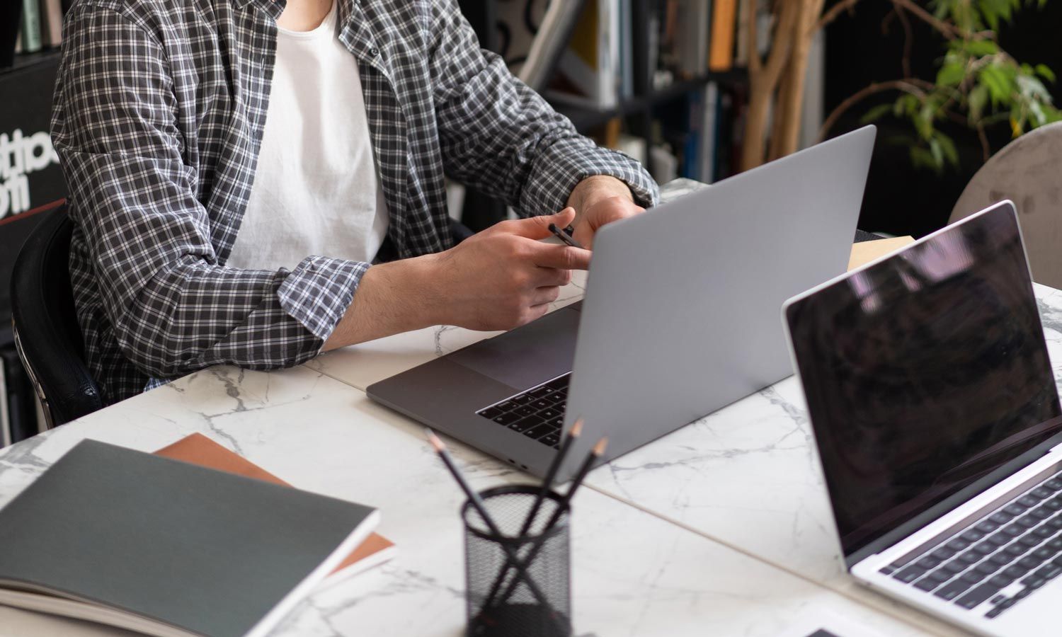 a man using a laptop on a marble table